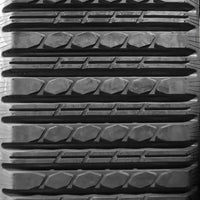 Black rubber tire tread with hexagonal and rectangular patterns on ASV PT100 Multi-Bar Rubber Tracks