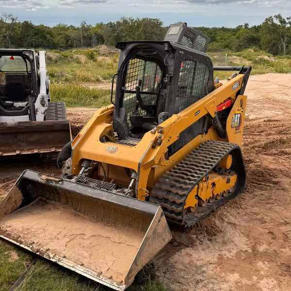 Close-up of a CAT 289D3 compact track loader showcasing its new zig-zag rubber tracks, which provide high-grade traction in mud, snow, and soft soils.