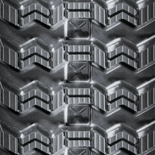 Close-up of BOBCAT T62 metal track with chevron grooves and embossed X pattern