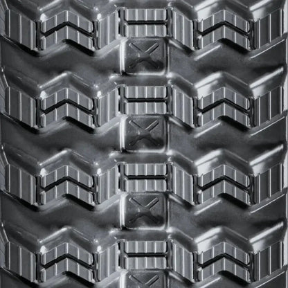 Close-up of CAT 299D3 heavy-duty tire tread with chevron pattern and rectangular blocks