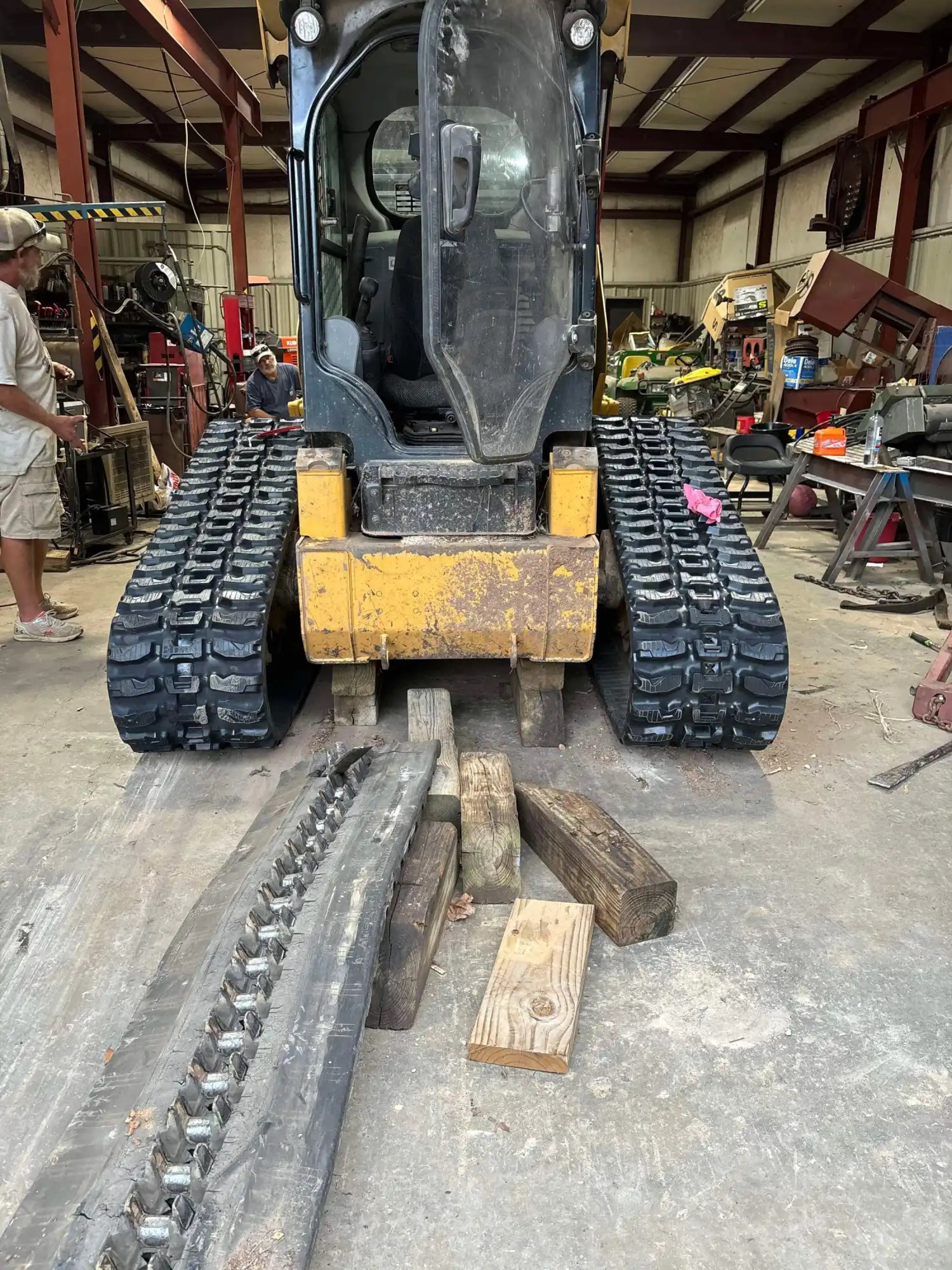 John Deere 333G compact track loader with new aggressive rubber tracks installed for superior traction