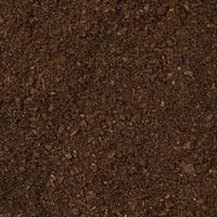 Rich, dark mud, illustrating the high flotation capabilities of zig-zag tracks to prevent bogging down in soft conditions.