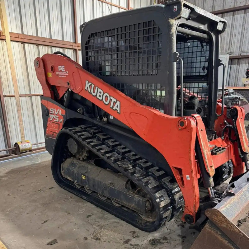 An orange Kubota SVL75-2 compact track loader showcasing premium new 400x86x52 rubber tracks, ready for heavy-duty operation.
