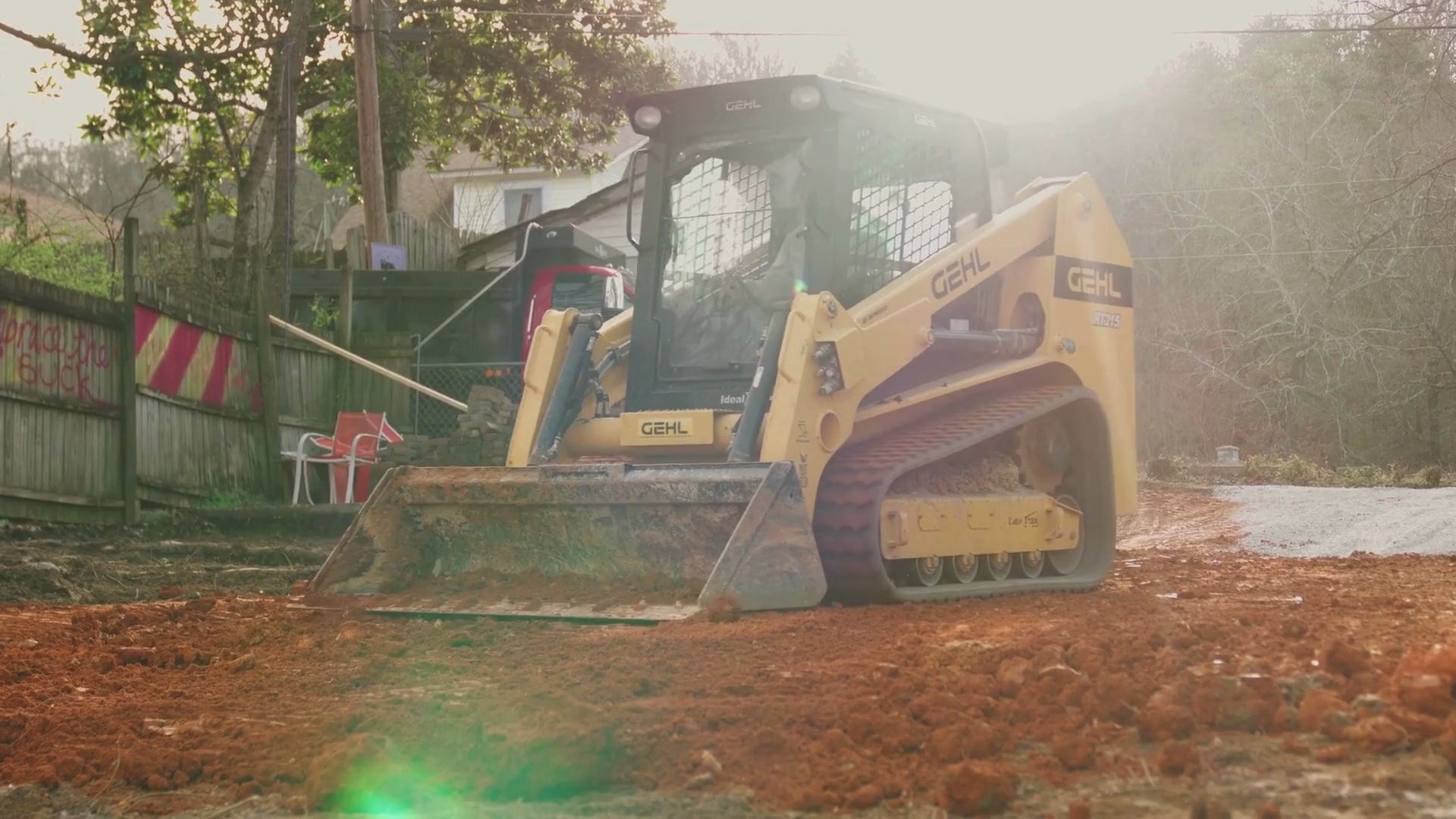 Load video: Gehl RT215 Skid Steer grading clay. 