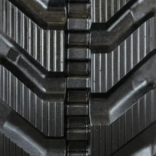 Close-up of TAKEUCHI TB235 rubber track with angled treads and rectangular lugs