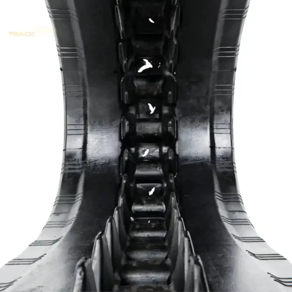 Black rubber track with central rib for traction on Takeuchi TL10V2 excavator