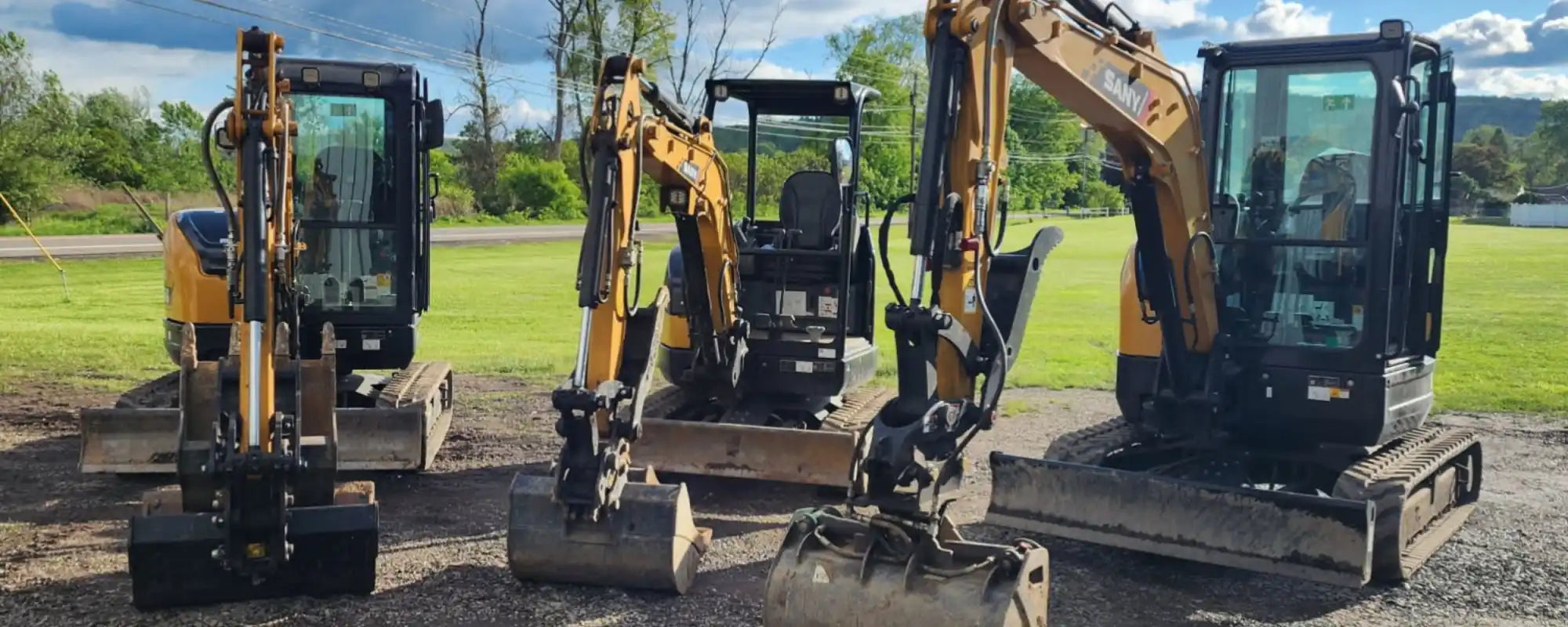 A fleet of rental mini excavators with new replacement rubber tracks, highlighting solutions for equipment rental businesses.