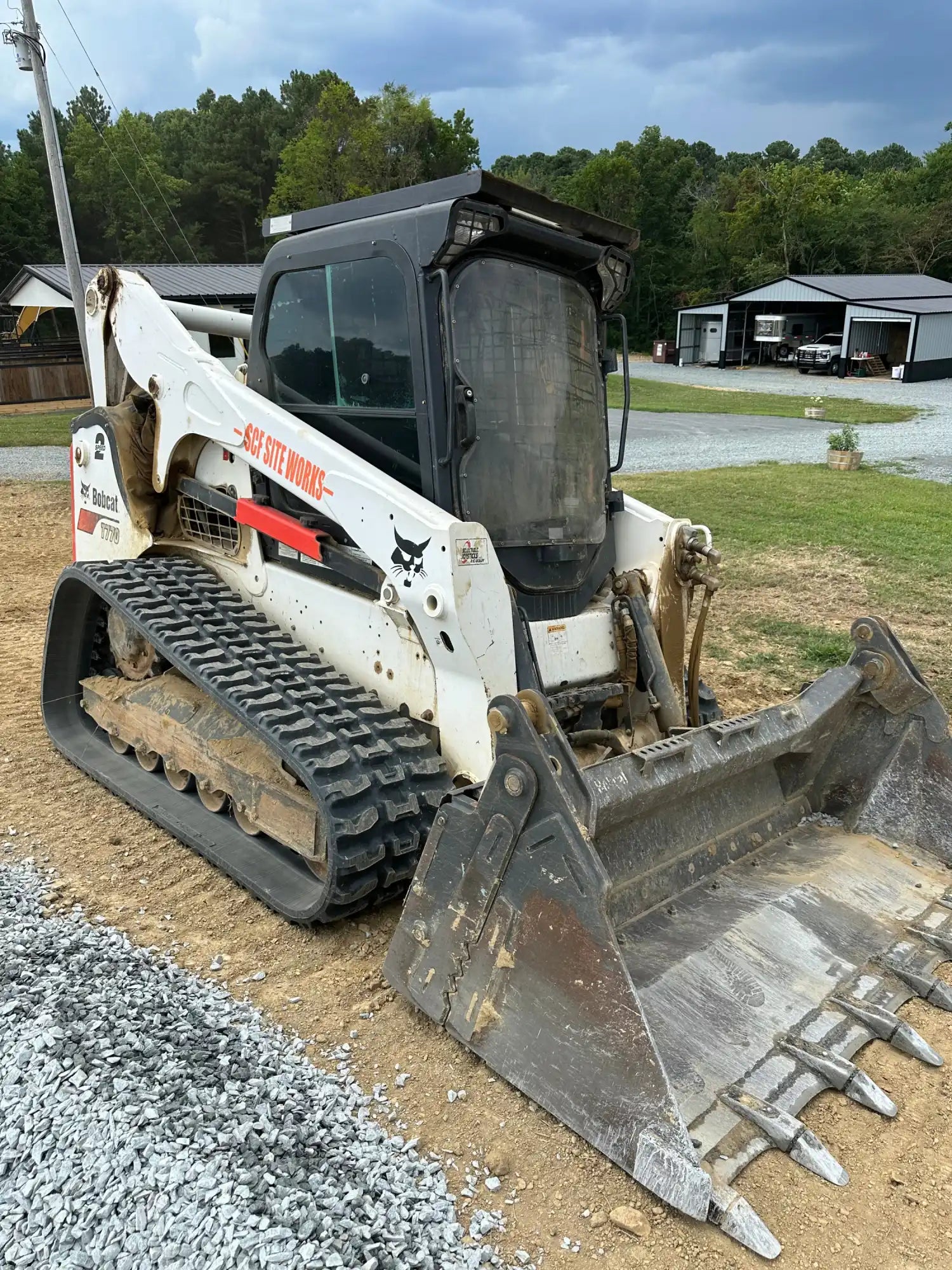 Bobcat T770 track loader with a bucket attachment on a construction site.