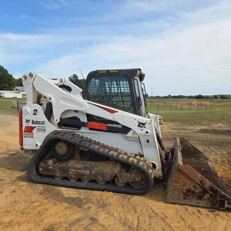 Bobcat T870 with new 18" wide c-block tracks  on a construction site with a clear sky.